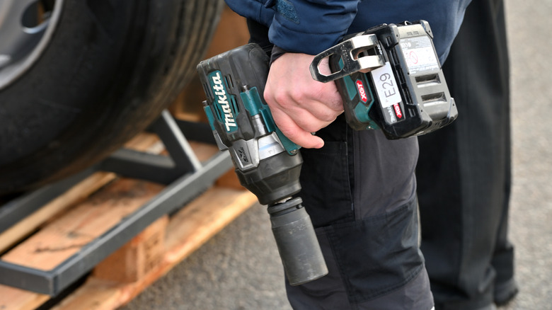 person holding Makita power tool