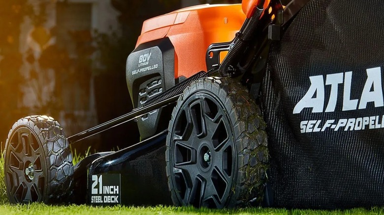 The side of an Atlas lawn mower on grass.