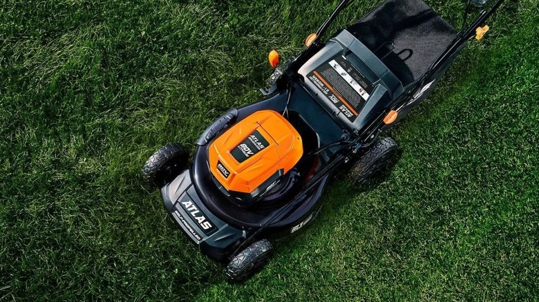 An Atlas lawn mower pushed through grass.