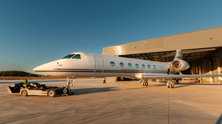 Gulfstream business jet being towed out of hangar