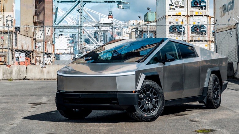A Cybertruck parked at a shipping dock