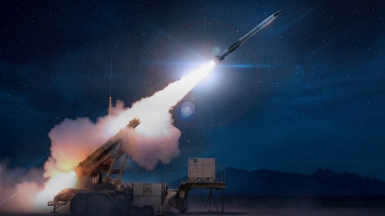 A Patriot Missile Launch System firing a PAC-3 Patriot Interceptor at night