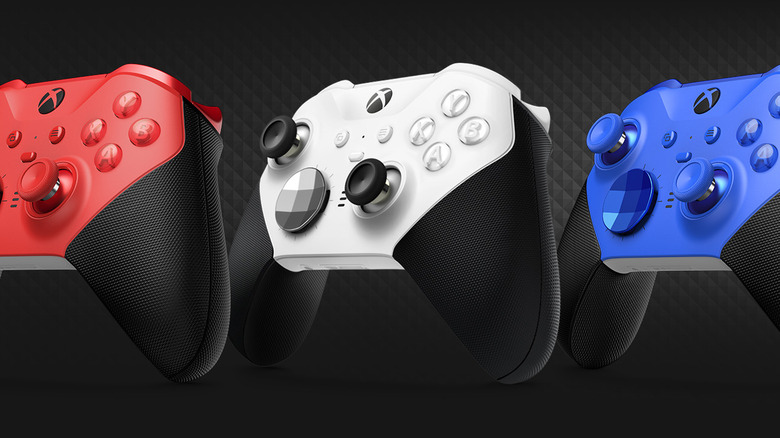 Three red, white, and blue xbox one elite series 2 controllers.