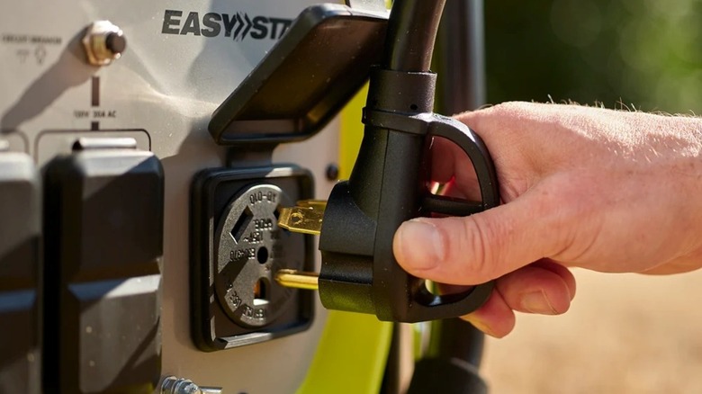 Plugging in to the generator's 30-Amp RV outlet.