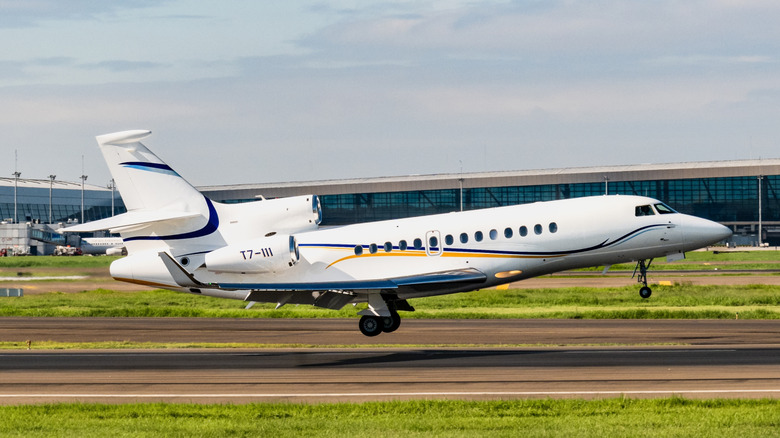 Dassault Falcon 7x private jet taking off at airport