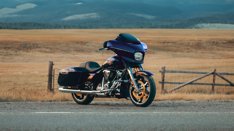 A dark blue 2025 Harley-Davidson Street Glide on a road, front 3/4 view