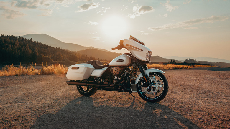 A white Harley-Davidson Road Glide on a sunny day, front 3/4 view