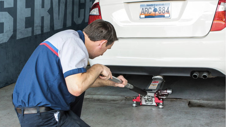 professional mechanic using floor jack