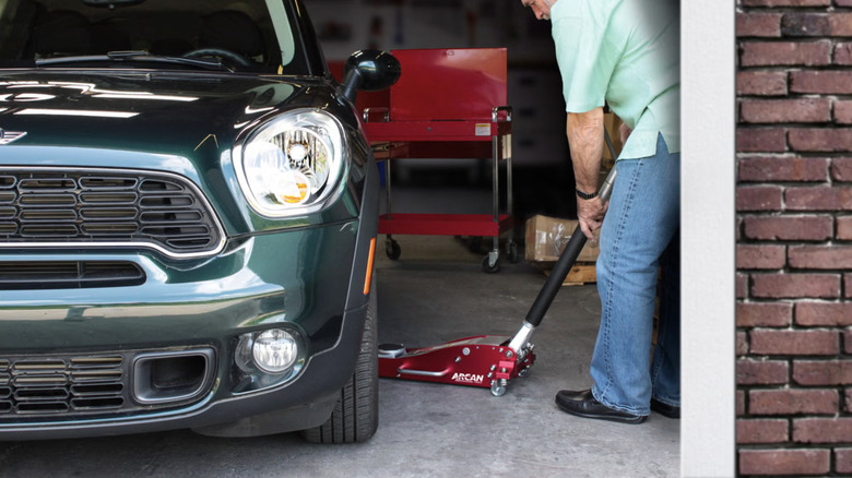 man using floor jack