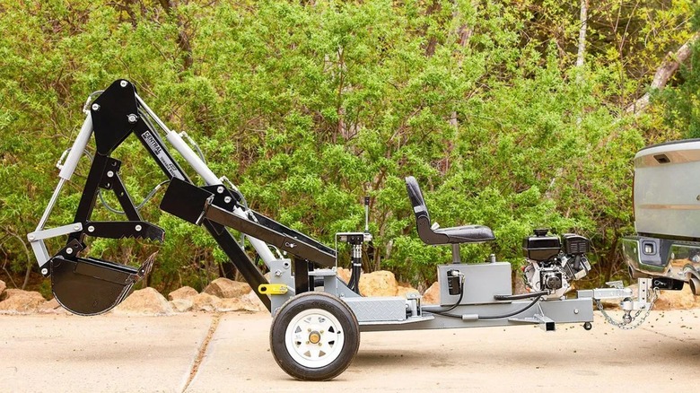 towable backhoe behind truck