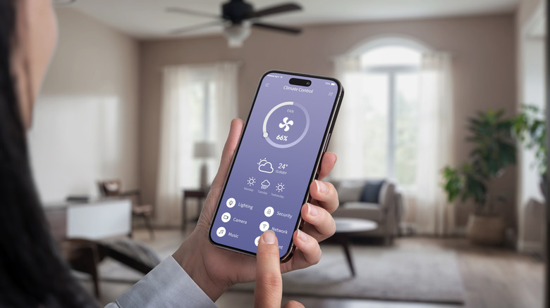 Woman using app to control smart ceiling fan