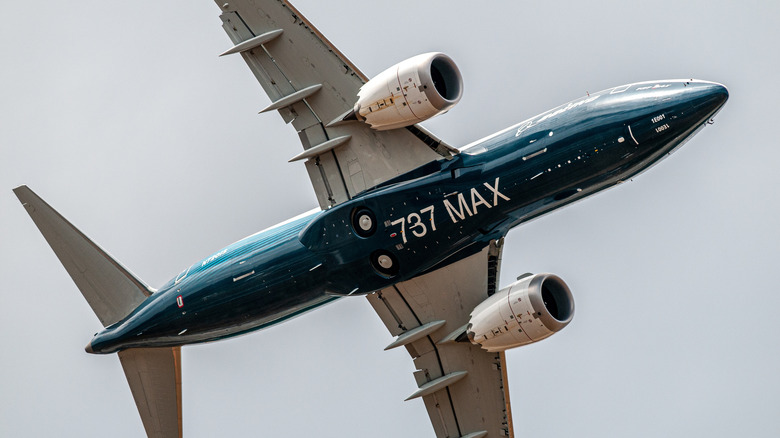 Underside view of a Boeing 737 Max promotional plane banking in flight
