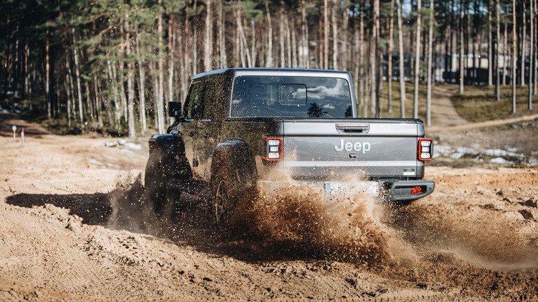 jeep gladiator racing through sand dunes