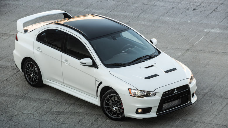 White Mitsubishi Lancer Evolution Final Edition parked on concrete