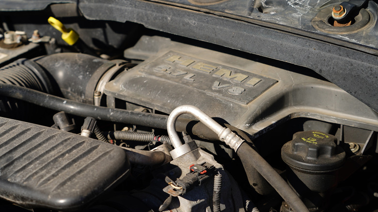 A 5.7-liter Hemi V8 under the hood of a Dodge Ram, slightly dirty engine cover
