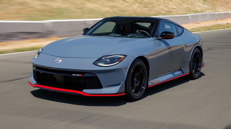 Nissan Z NISMO driving next to a grassy hill