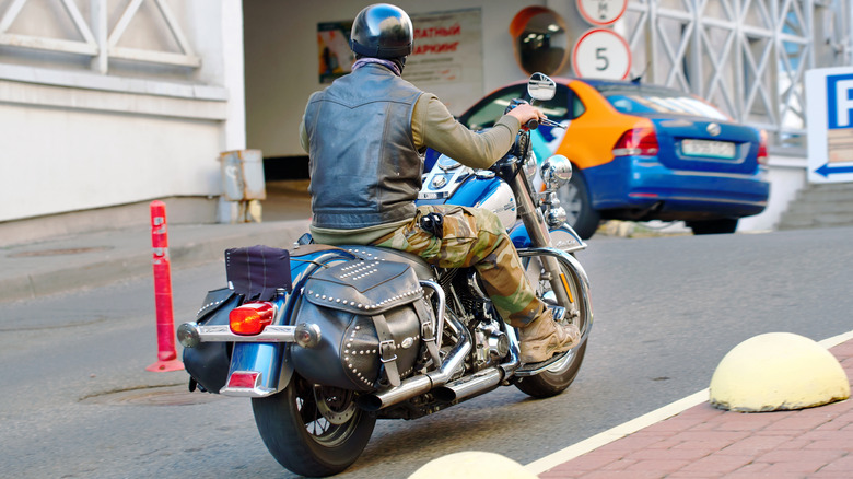A biker pulling into a parking lot