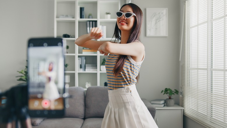 girl dancing in front of smartphone