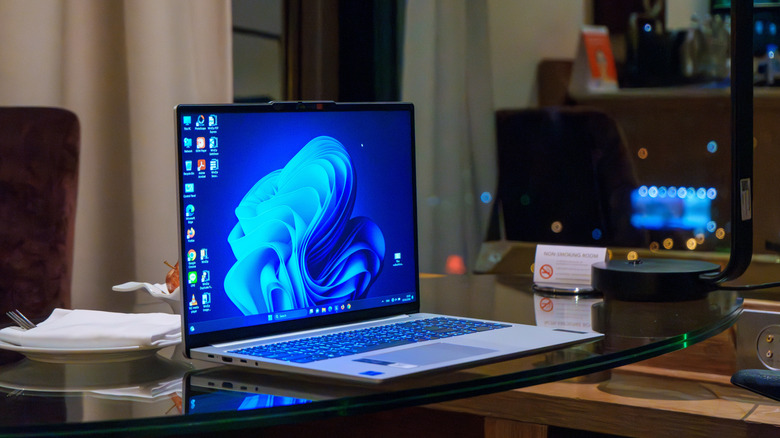 A Windows laptop placed on a glass table.