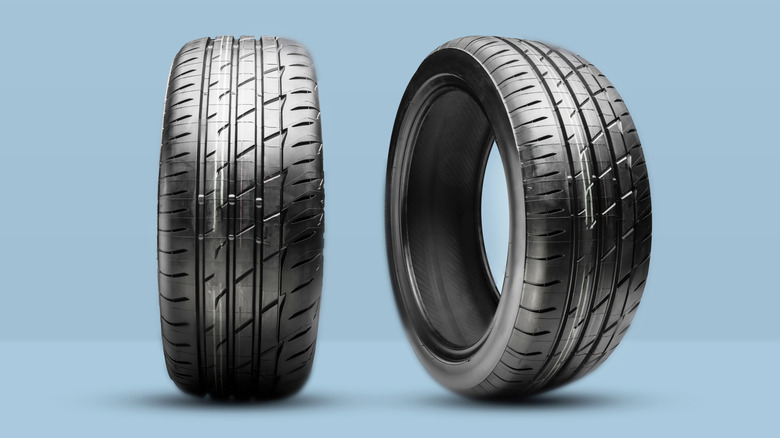 Two tires upright next to one another on a blue background