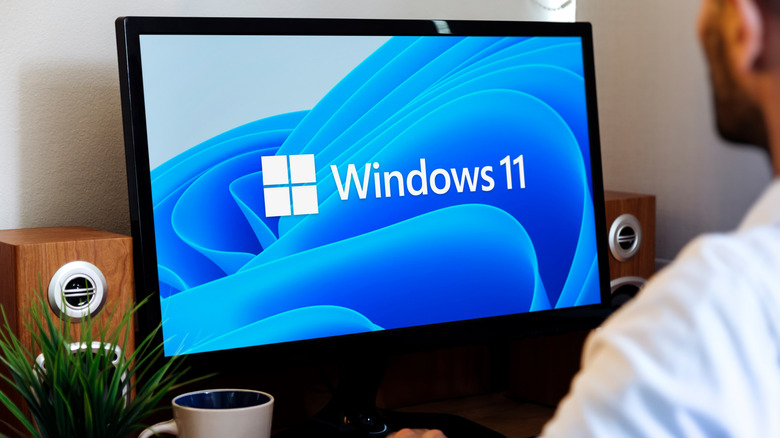 Man using a computer showing the Windows 11 logo