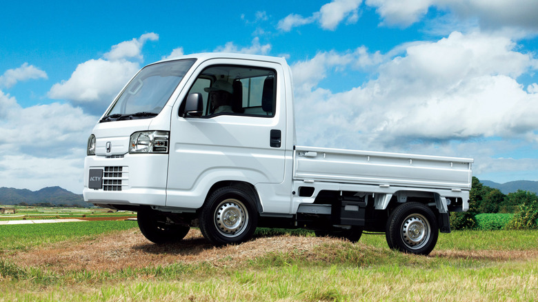 2021 Honda Acty kei truck parked on dirt mound, left-side view