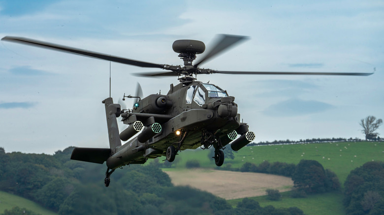 AH-64 Apache flying with grassy background