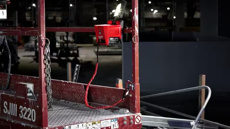 A Milwaukee tool lanyard attached to a Milwaukee light.