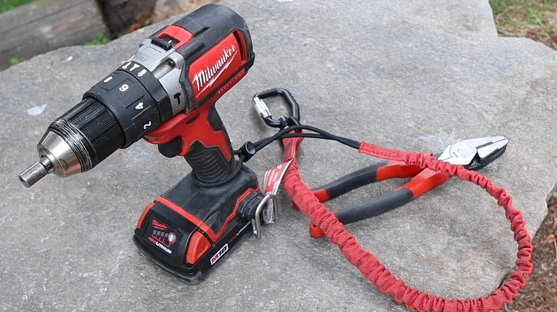 A drill attached to a Milwaukee tool lanyard.
