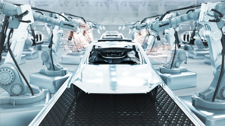 Robotic arms manufacturing a car