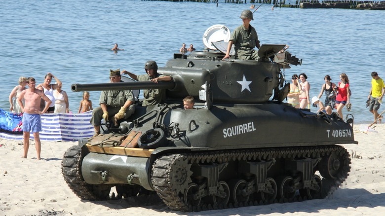 An M4 Sherman tank on a crowded beach