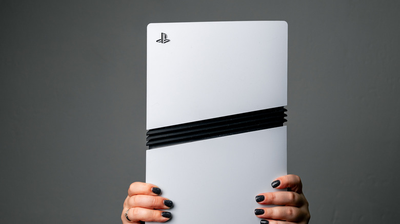 Person holding a PS5 Pro.