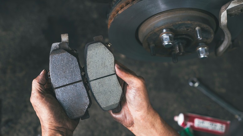Person replacing a brake pad
