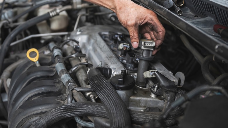 Mechanic inspecting the ignition coil