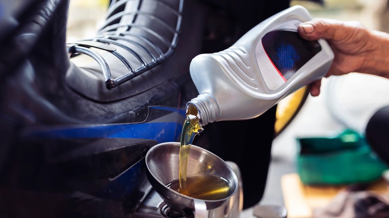 Mechanic changing motorcyle oil