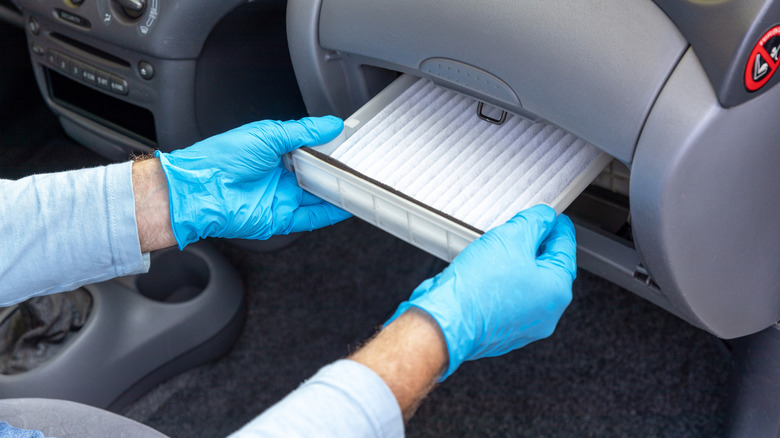 Close-up shot of a technician inserting a new cabin air filter