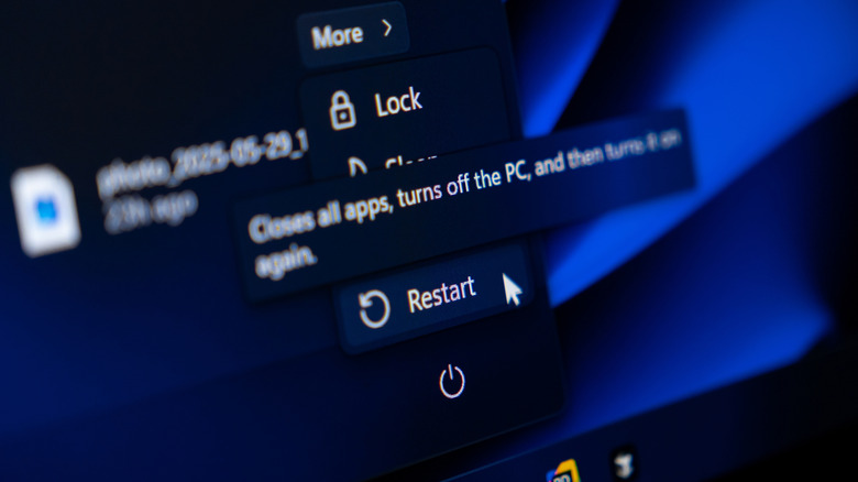 A close up image of a mouse pointer overing over the restart option in the power menu on a Windows PC