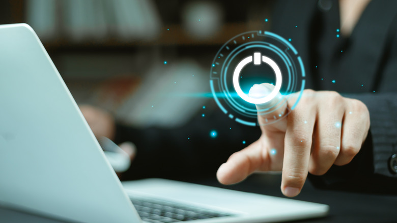 An image of a user with a laptop with an illustration of them pushing a virtual power button