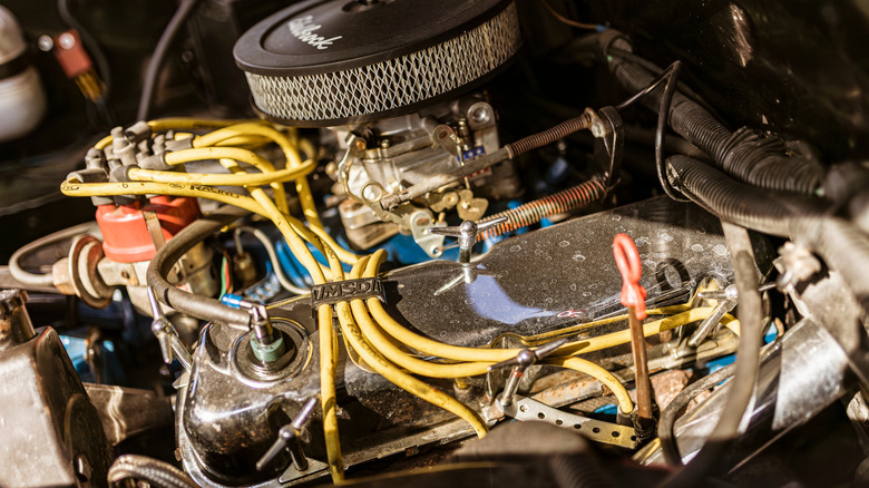 Close up image of engine with yellow spark plug cables