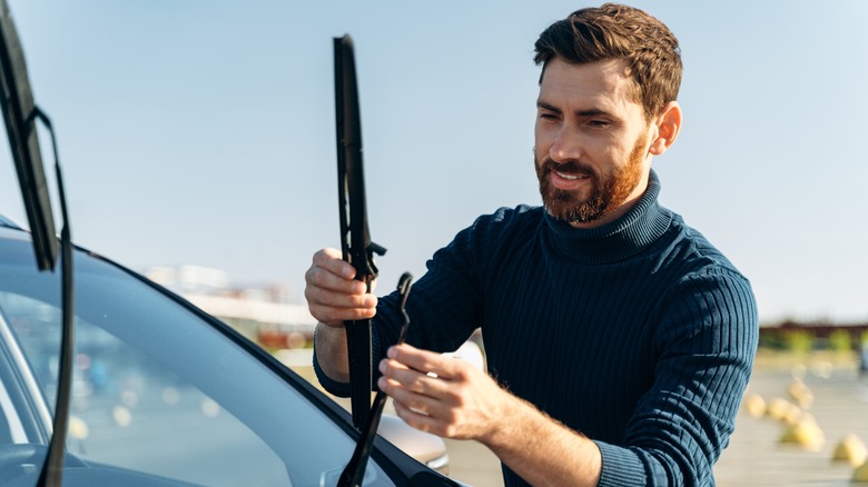 Man fixing windshield wiper