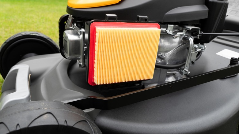 An air filter on a push lawn mower.
