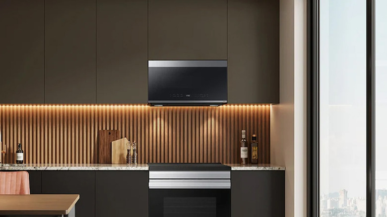 A Samsung Bespoke microwave over an oven range in a modern kitchen.