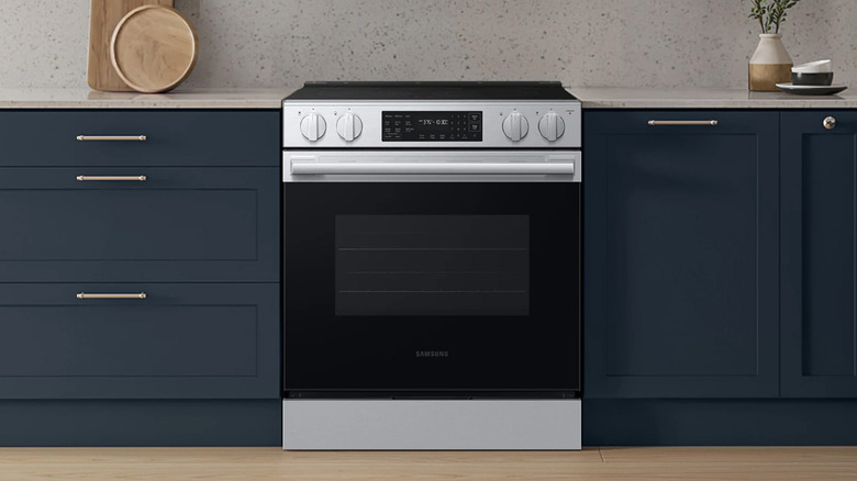 A Samsung oven and range in a blue and white kitchen.