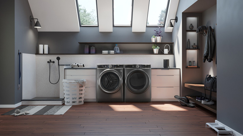 A GE washer and dryer set in a laundry room with skylights.