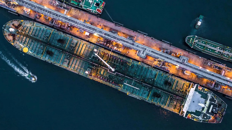 Top-down view of large cargo ship docked in industrial port