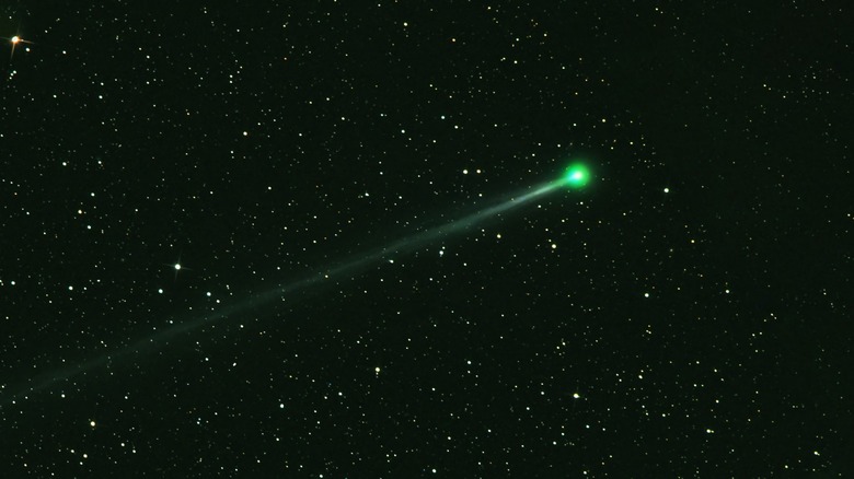 green comet flying through the night sky