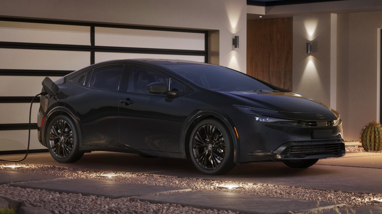 A black 2025 Toyota Prius Plug-In Hybrid charging
