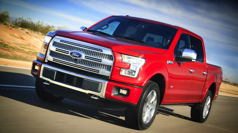 2014 Ford F-150 driving on road, front-left 3/4 view