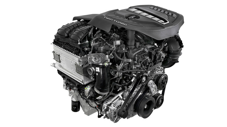 Hurricane 3.0L twin-turbo straight six detail view on white background, front-right perspective