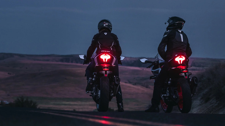 Two riders on CFMoto 450SS bikes